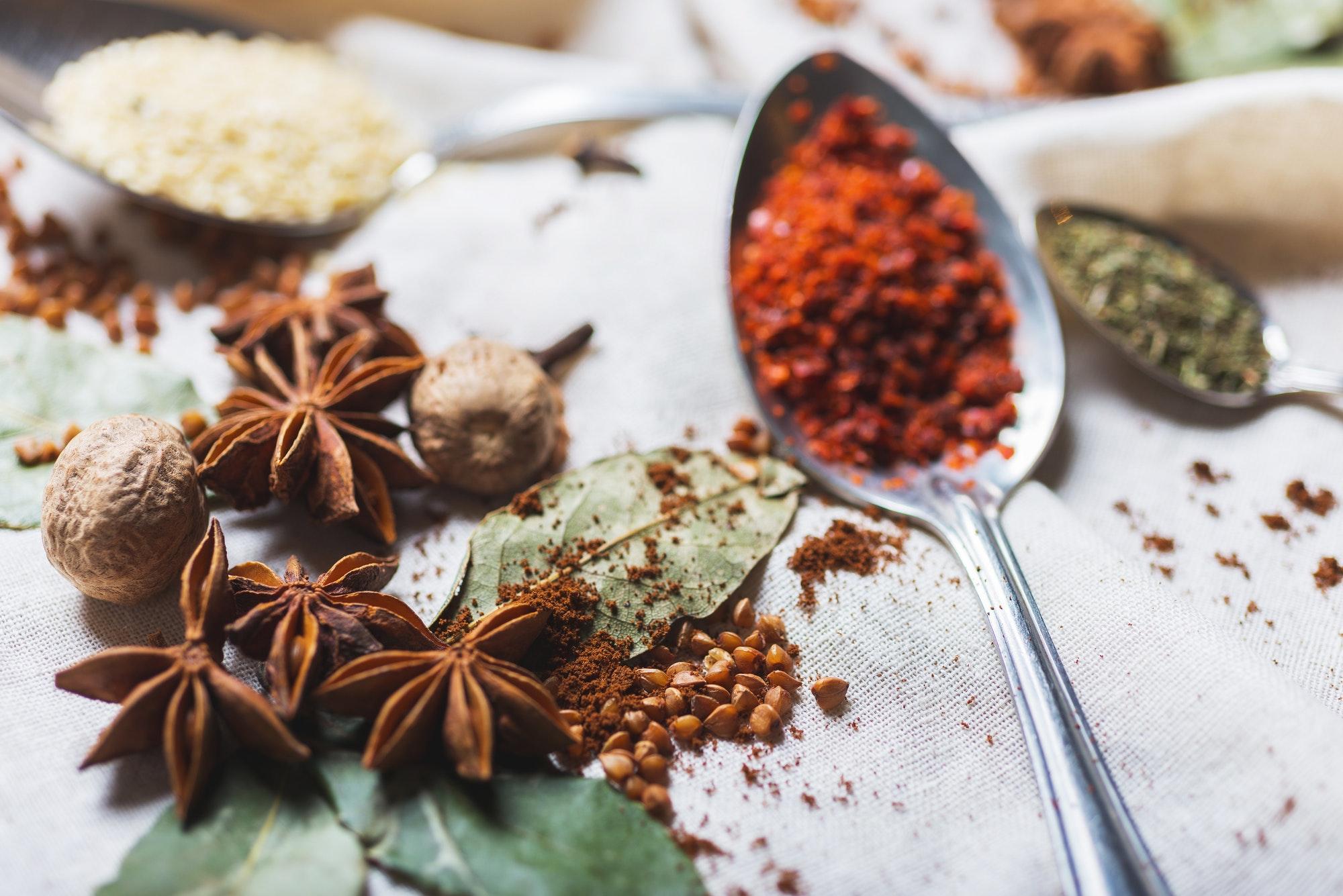 mix of different spices and herbs on a table with decor